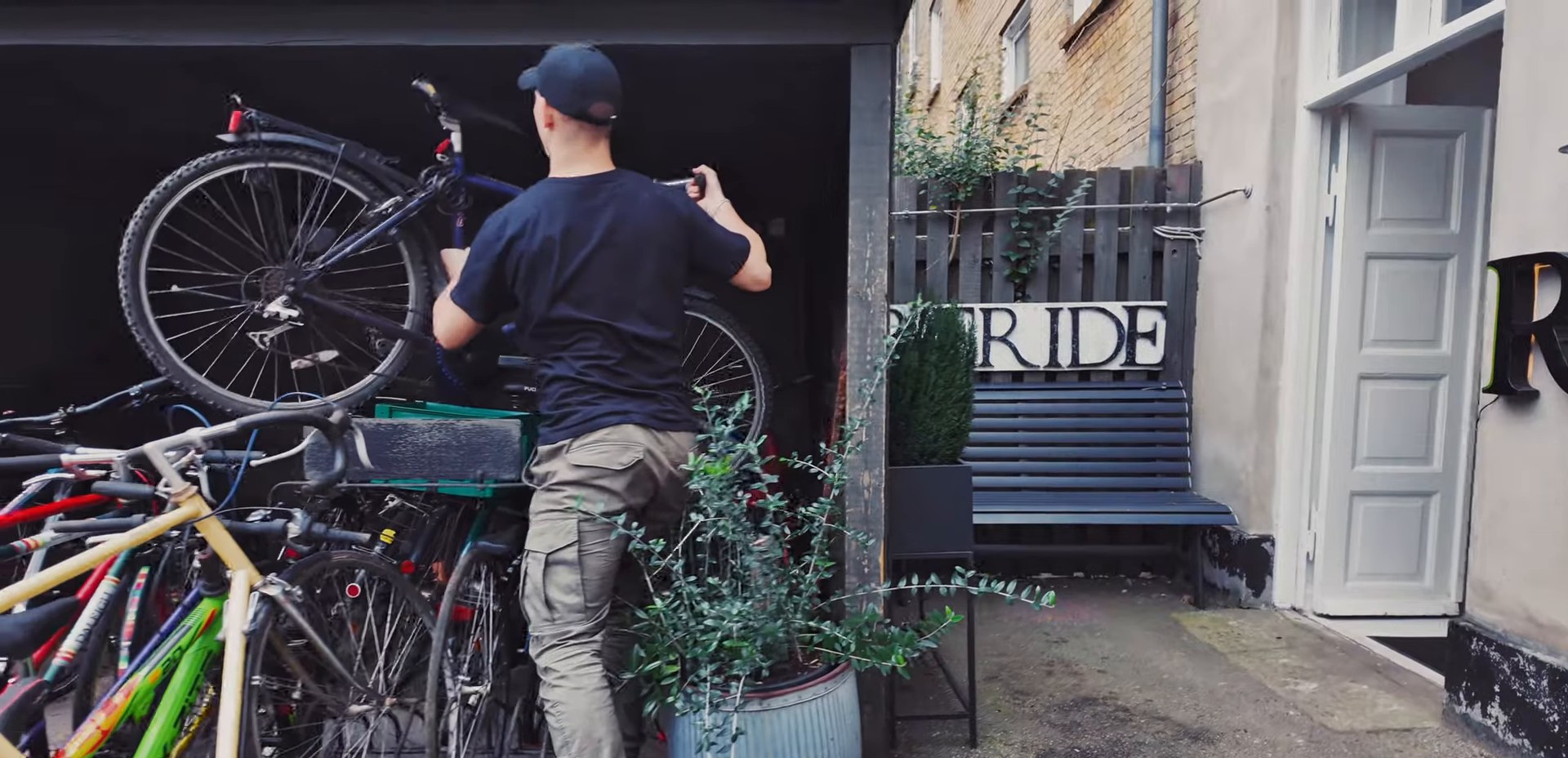 Moving a bicycle in the courtyard at the Reride workshop in Valby